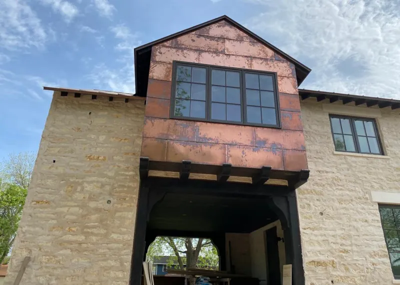 Copper metal panel facade on a stone building for Skylight Installation in Bradfordville